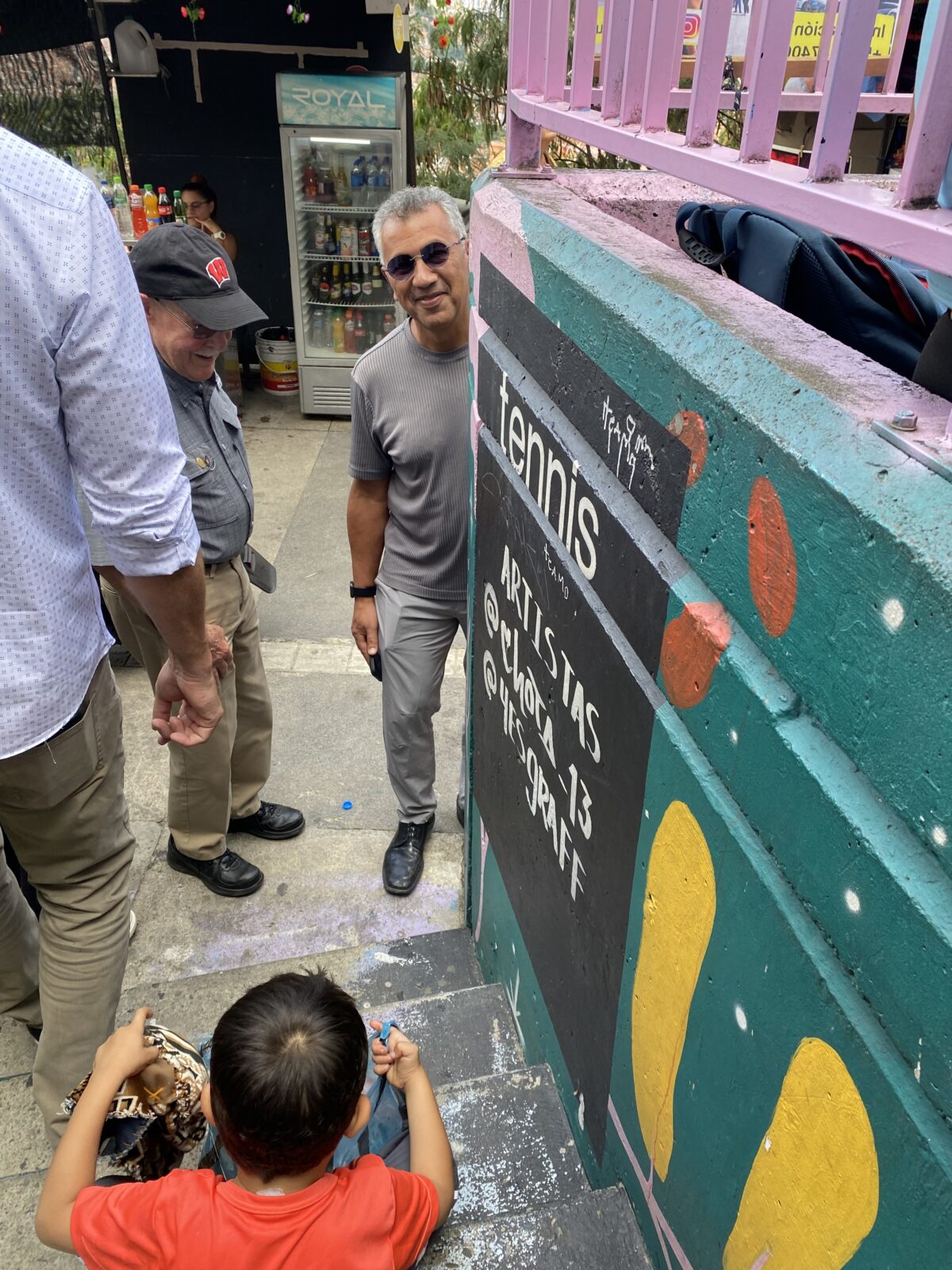 Jorge Osorio & Tom Yuill pause to chat with young resident in Comuna 13, Sep 2023