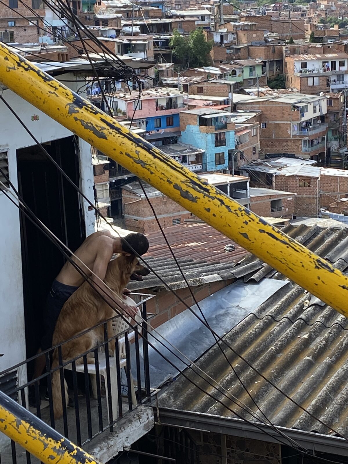 Comuna 13 scene with man and dog, Sept 2023
