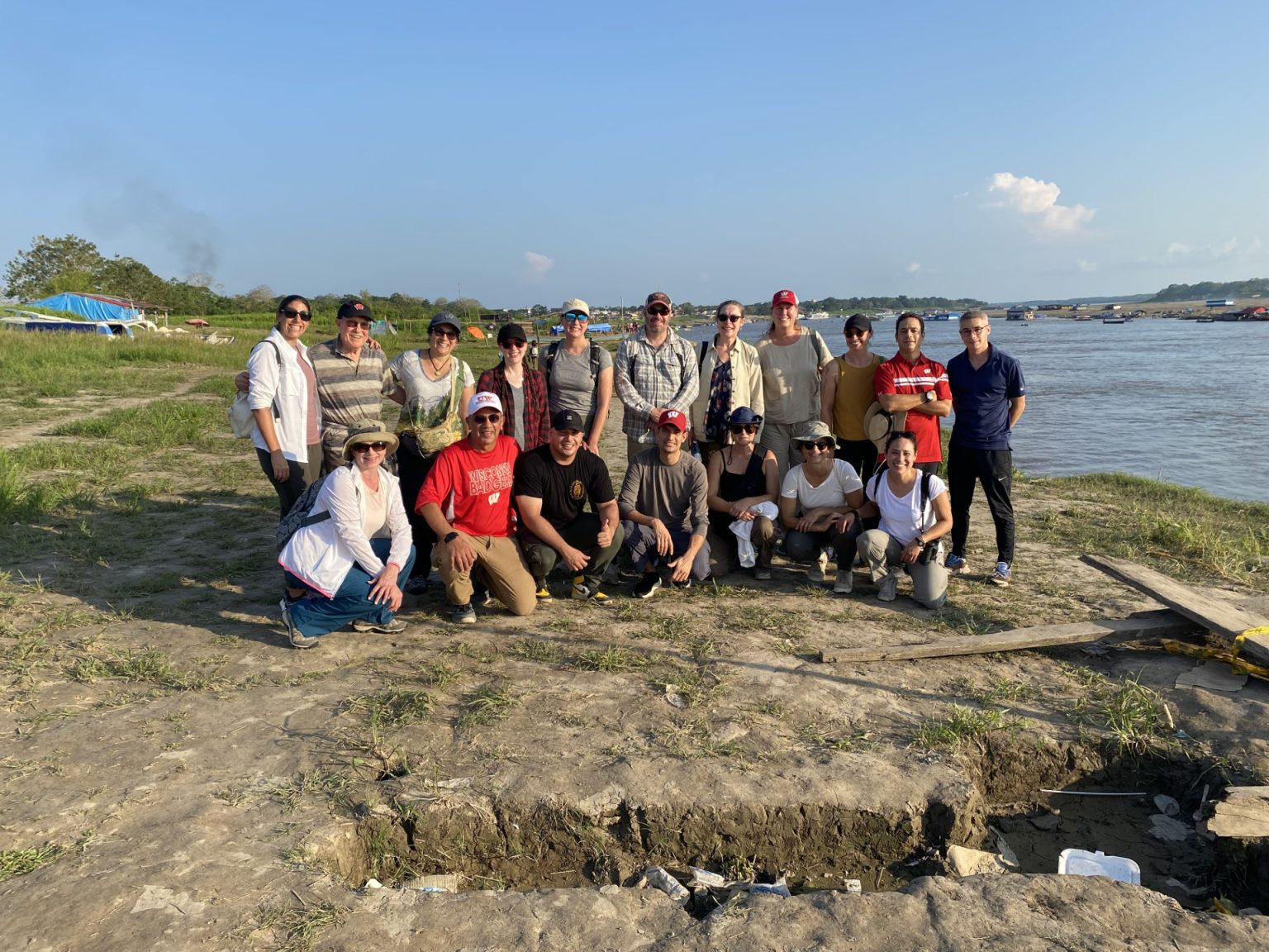 UW Madison Colombia delegation poses on the banks of the Amazon river