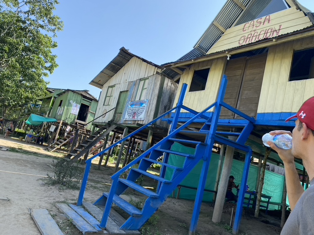 Exposed stairways and stilts of homes near the receding Amazon River shore, Sept 2023