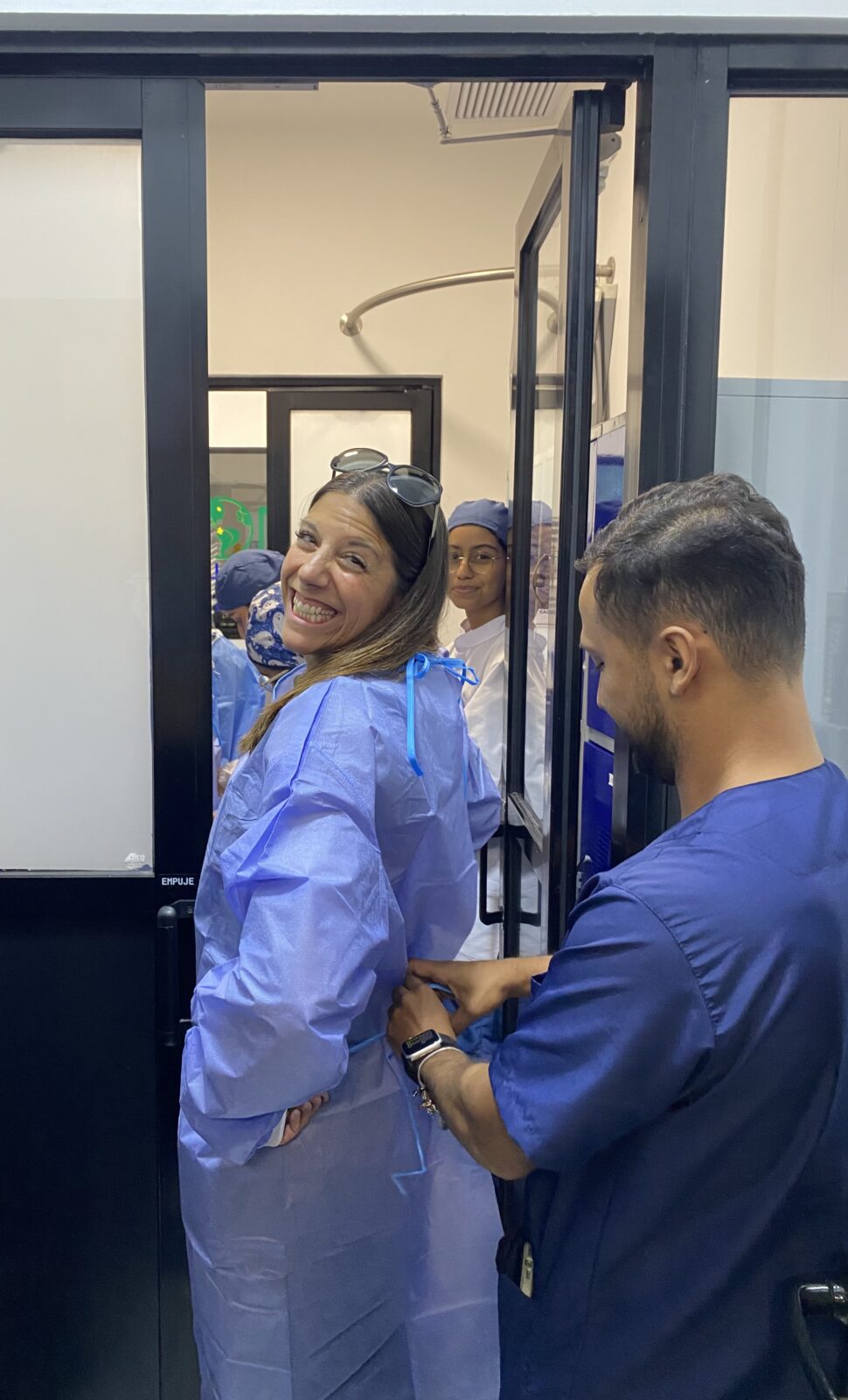 UW Madison's Nikki Davis suits up prior to entering sterile area of GHI OHC-Colombia, Sept 2023