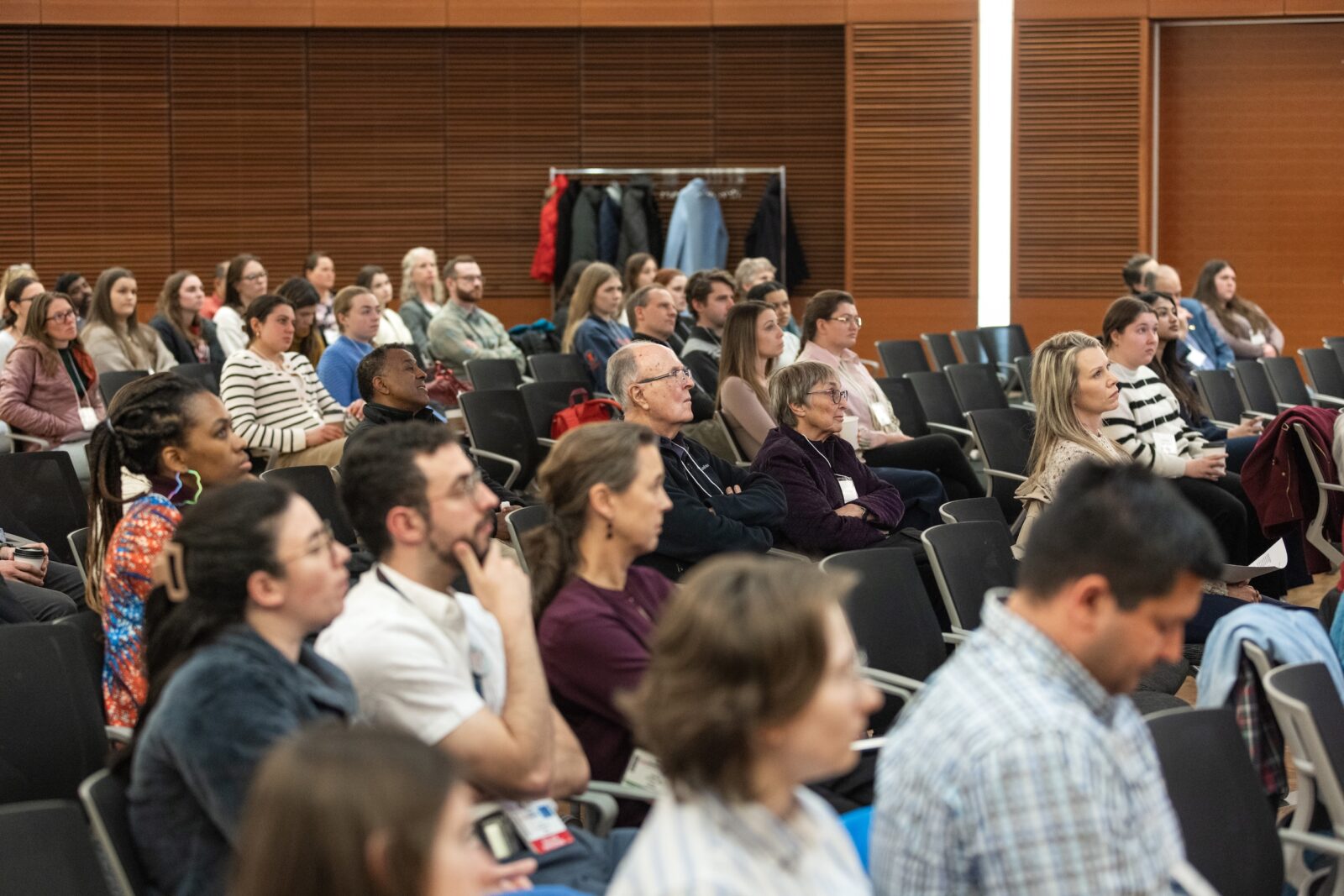 attendees sitting in chairs listening