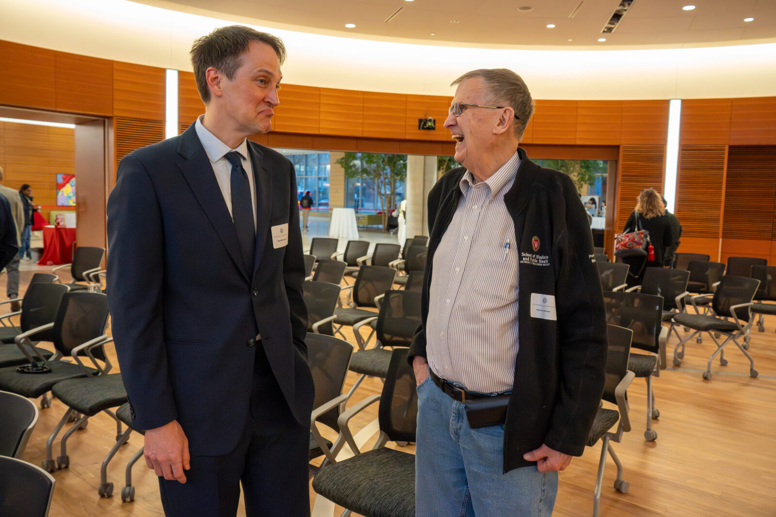 Photo from 2026 Global Health Symposium at the Discovery Building; Ryan Westergaard speaking with a guest
