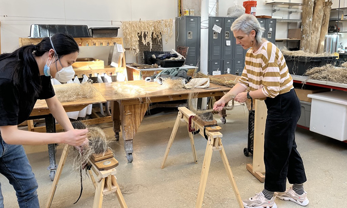 June 2022 Two people working with hemp fibers to make paper