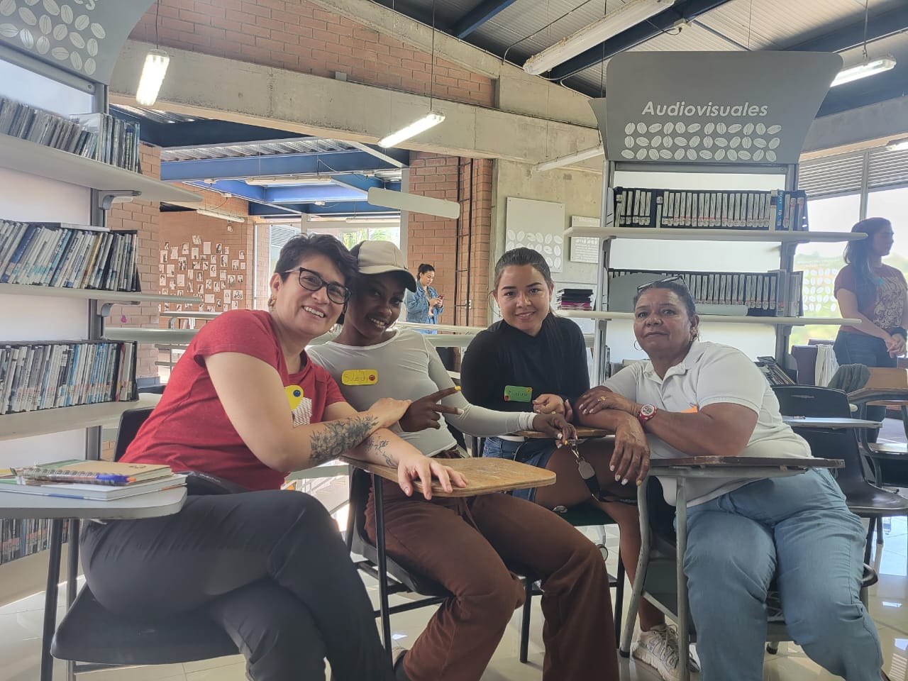 June 2024, four people sitting and posing in a mall like setting
