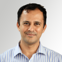 November 2024, man with dark hair and striped shirt against a light grey background