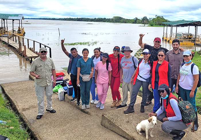 June 2022 a group of researchers on a concrete pad next to the Amazon