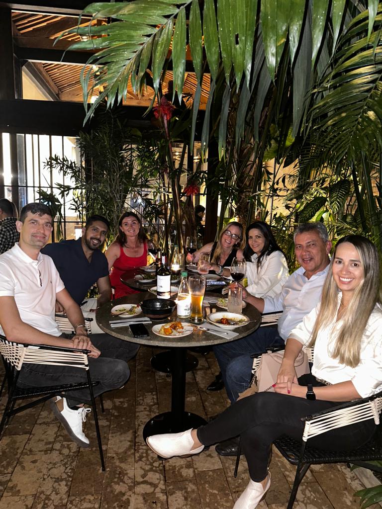 May 2024, people sitting at a table at a restaurant with trees in the background