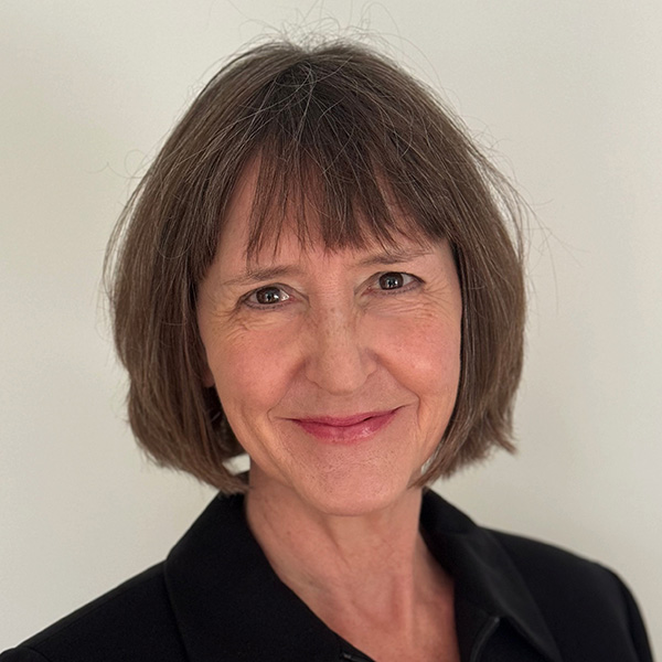 headshot of Traci Toomey; woman with dark hair wearing a dark top against a light background