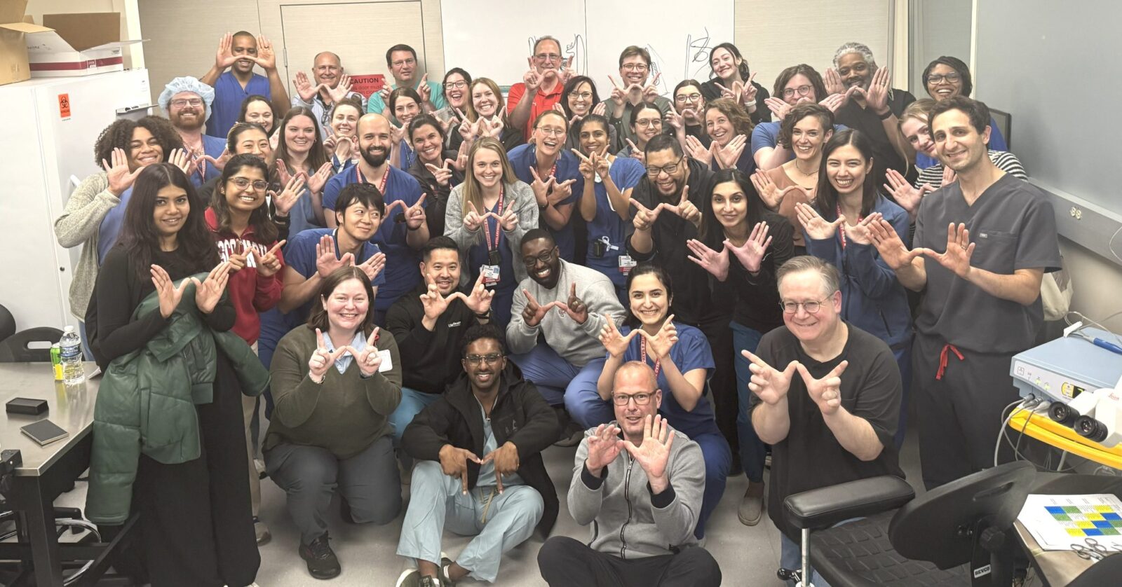 group of people giving the UW W
