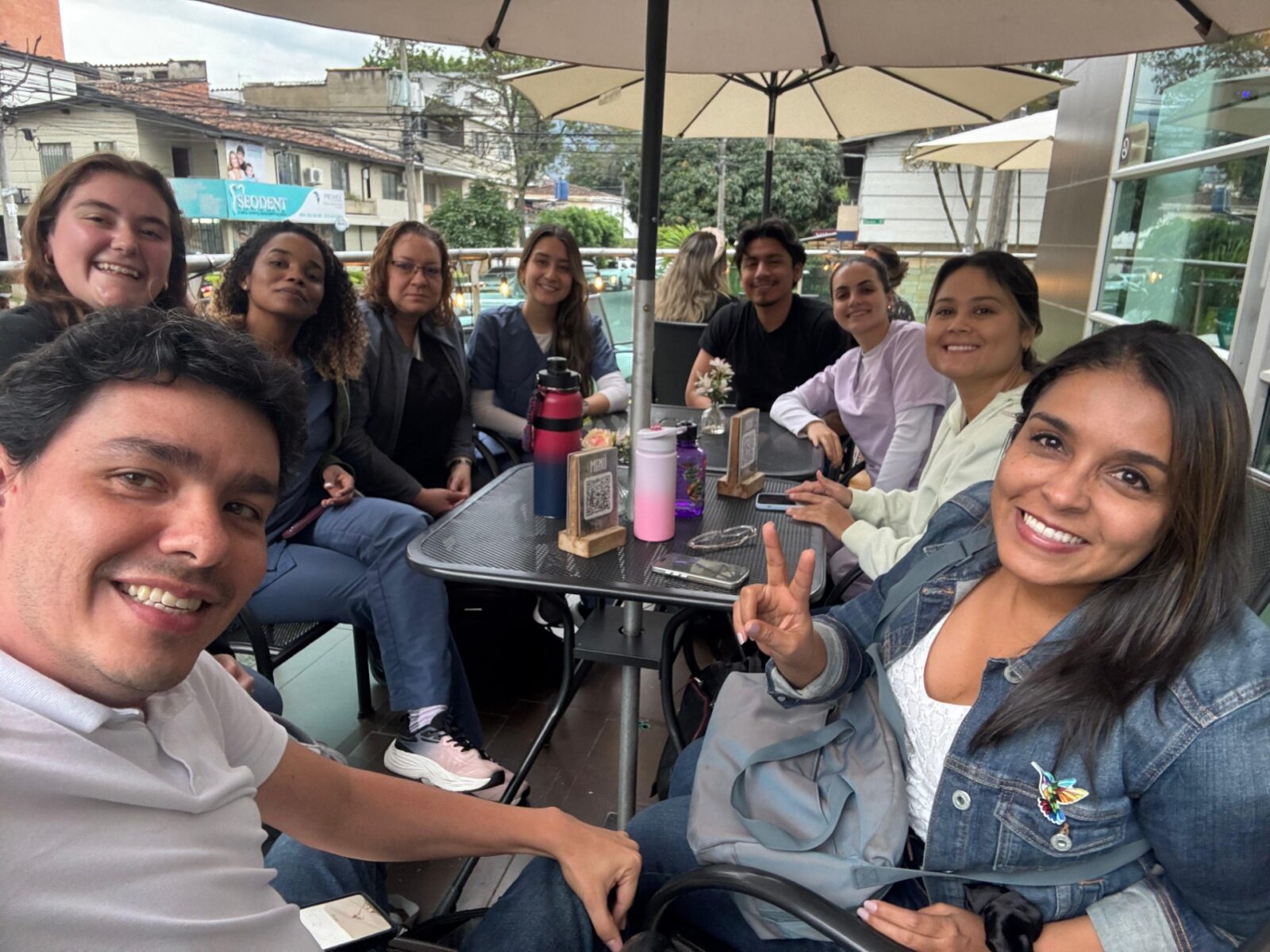 Nine people sitting at a cafe
