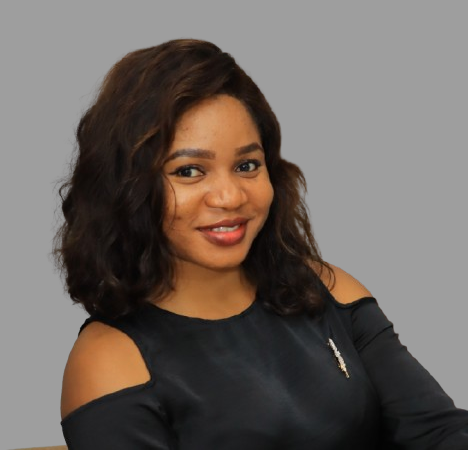 headshot of Damilola Odekunle, a black woman with dark hair and a dark top against a grey background