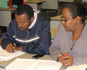 Balkachew Nigatu and Kidest Hailu work together on a plan to improve communication between mothers in labor and their families in the hospital waiting room.