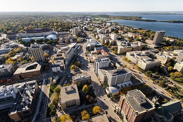 The central University of Wisconsin-Madison campus is pictured in an aerial view during autumn on Oct. 12, 2013. Clockwise from the bottom center, major campus facilities include the Chemistry Building, Noland Zoology Building, Charter Street Heating and Cooling Plant, Weeks Hall for Geological Sciences, Atmospheric, Oceanic and Space Science Building, Computer Sciences and Statistics, Wisconsin Institutes for Discovery (WID), Medical Sciences Center and Chamberlin Hall. In the background from left to right are Camp Randall Stadium, Lake Mendota and Picnic Point. The photograph was made from a helicopter looking west. (Photo by Jeff Miller/UW-Madison)