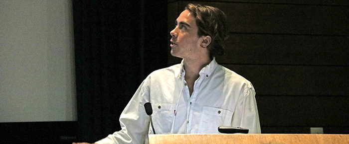 Male student talking from podium.