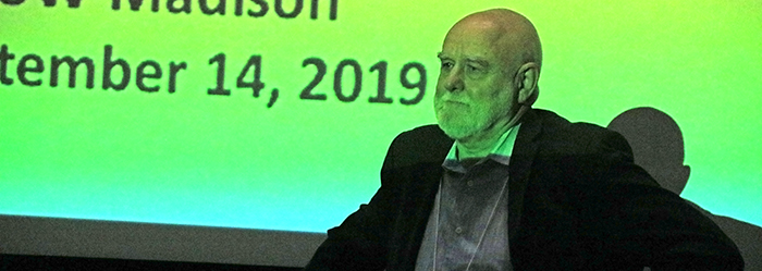 Steve Hargarten stands in front of the screen.