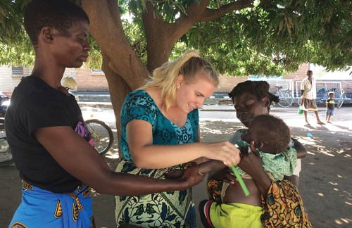 Kohlmann working with the children in the field