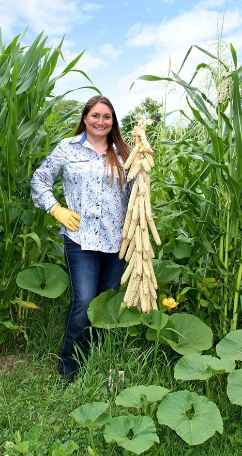 Rebecca Webster holds a braid of Indigenous corn from her Oneida garden.