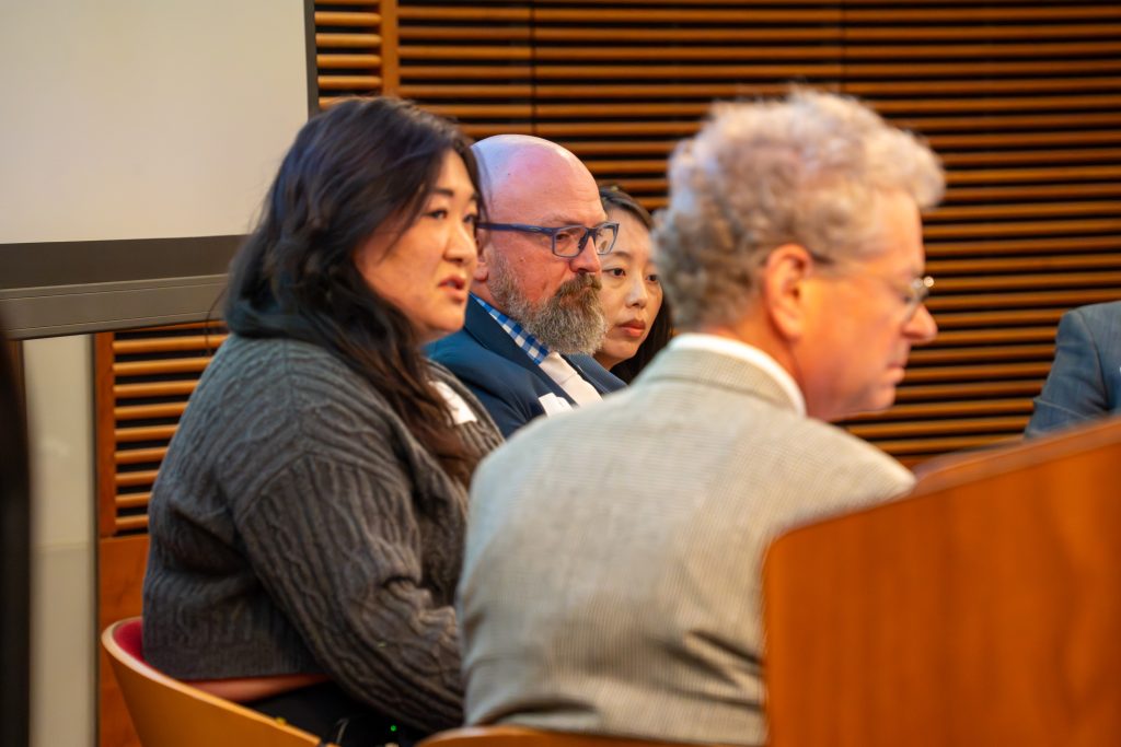 Photo from 2026 Global Health Symposium at the Discovery Building; 2026 panel sitting on a stage from a side angle