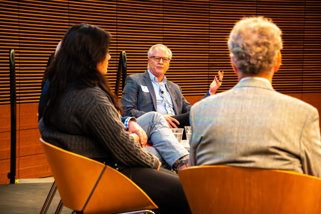 Photo from 2026 Global Health Symposium at the Discovery Building; Dr. Conway sitting with a panel of speakers